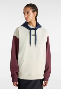 Felpa con cappuccio di colore crema con maniche bordeaux e dettagli blu scuro. Presenta una tasca frontale e il logo "VANS" sul petto.