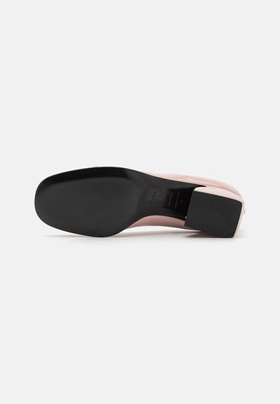 Scarpa con tacco alto rosa con una superficie liscia, punta quadrata, suola nera e tacco a blocco progettato per la stabilità. Nessun motivo o decorazione visibile.