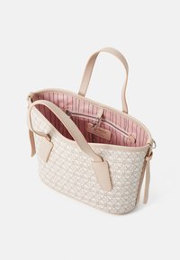 Cream patterned handbag with pink striped lining, features soft leather handles, an interior zip pocket, and decorative hardware accents.