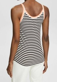 Svartvit randig linne med persikofärgad kant, med en slim fit, tunna axelband och en mjuk tygstruktur.