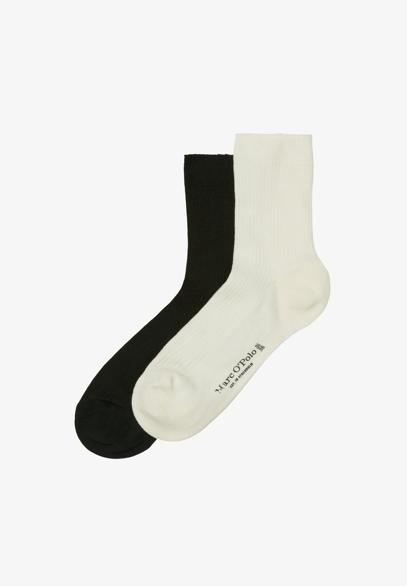 Bawełniane skarpetki w czarno-białym kolorze, o żebrowanej fakturze, długości do połowy łydki. Posiadają nadruk logo w pobliżu kostki na białej skarpetce.