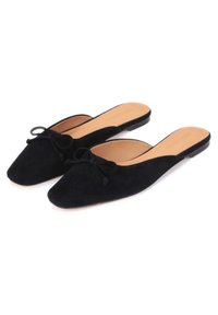 Black suede mules with a pointed toe and a small bow detail on the front. The interior features a light tan finish. Flat soles.