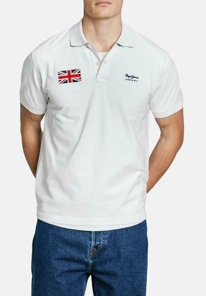 White polo shirt with a folded collar, featuring a Union Jack patch on the left chest and brand logo embroidered in black. Classic fit.