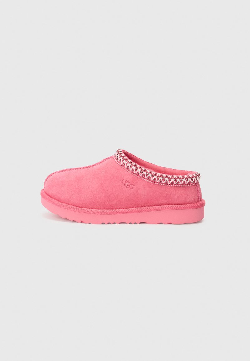 Pink suede slip-on shoe with a textured trim and rubber sole. Features a rounded toe and stitched detailing around the upper.