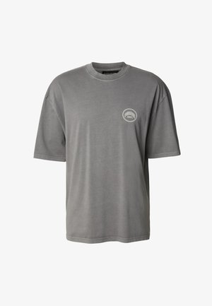 Gray cotton t-shirt with short sleeves, crew neck, featuring a small circular logo on the left chest. Soft texture and relaxed fit.