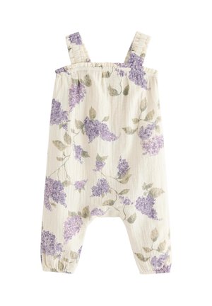 Kermanvärinen vauvan haalari, jossa on violeteilla liljakuvioilla koristeltu kukkakuvio, olkaimet ja joustavat lahkeensuut.