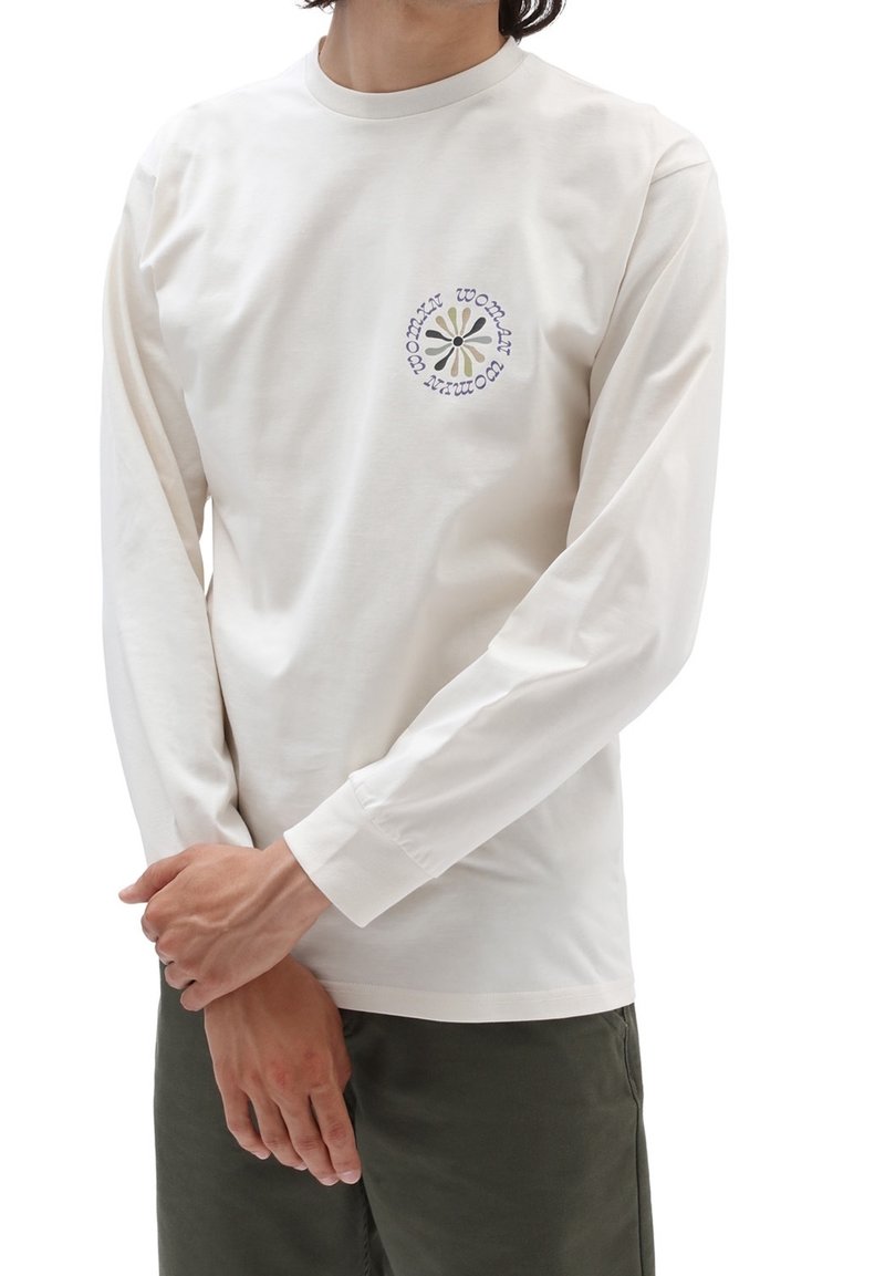 Camiseta de algodón crema de manga larga con un gráfico floral circular en colores suaves en el lado izquierdo del pecho, con un ajuste regular y cuello redondo.