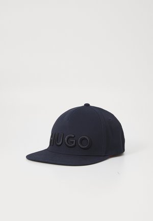 Navy blue cap with a structured shape, featuring an embroidered "HUGO" logo on the front and a flat visor. Made from smooth fabric.
