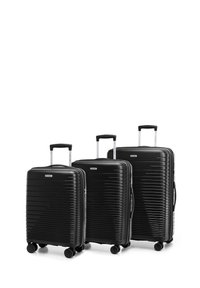 Set van drie zwarte harde koffers met horizontale ribbels, uitschuifbare handvatten en vier wielen voor gemakkelijke mobiliteit.
