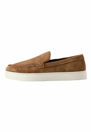 Brown suede slip-on shoe with white rubber sole, rounded toe, and stitching details along the upper edge.