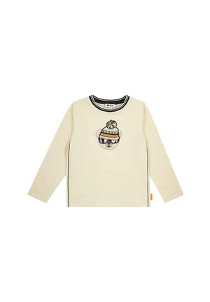 Cream long-sleeve shirt with black trim and a bear face wearing a green and orange knit hat and sunglasses on the chest.