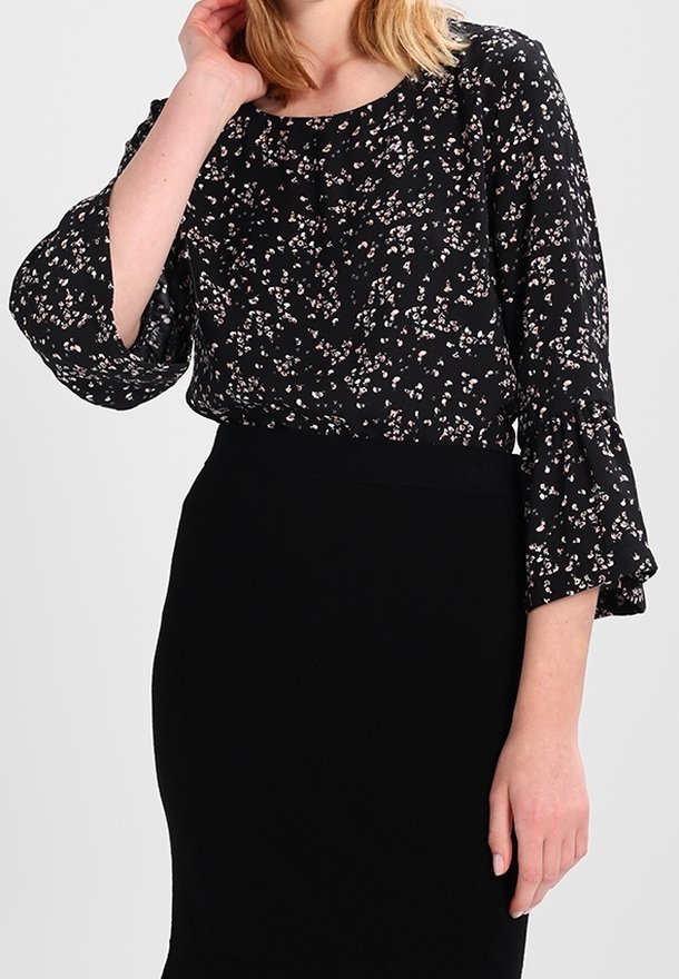Black floral blouse with three-quarter bell sleeves and a round neckline, featuring small pink and white flower patterns. Paired with a black skirt.