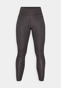 Leggings noirs avec un motif texturé de tourbillons et de lignes, une taille haute et un design ajusté qui descend jusqu'aux chevilles.
