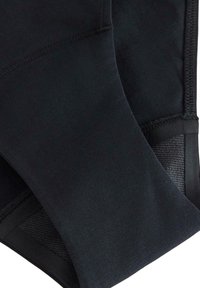 Leggings sportivi neri realizzati in tessuto liscio ed elasticizzato. Presentano un inserto in rete e cuciture rinforzate, progettati per garantire comfort e flessibilità.