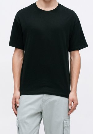 Black cotton t-shirt with a classic crew neckline and short sleeves, featuring a relaxed fit and smooth texture.