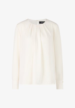 Cream blouse with long sleeves, round neckline, pleated front, and buttoned cuffs. Smooth fabric with subtle sheen and back closure.