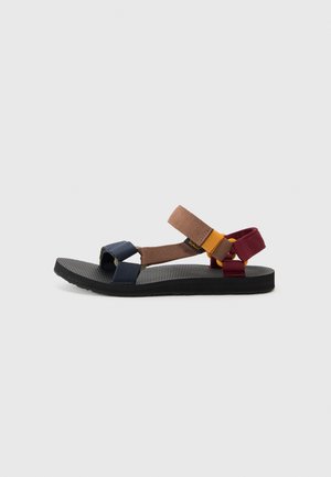Multicolored sandal with strap design. Features navy, brown, and burgundy straps on a textured black sole. Lightweight and open-toed.