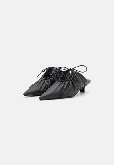 Black leather mules with a gathered design, pointed toes, and a small heel. Features a drawstring accent for adjustable fit.