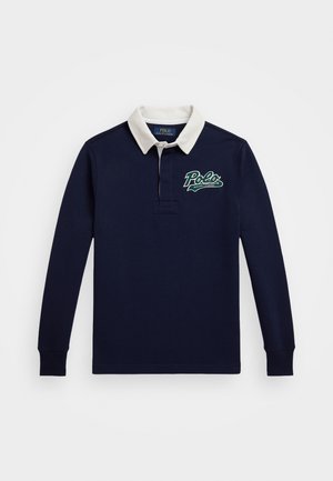 Námornícke polokošele s dlhým rukávom a bielym golierom, s zeleným logom "Polo" na hrudi. Vyrobené z hladkej bavlnenej látky.