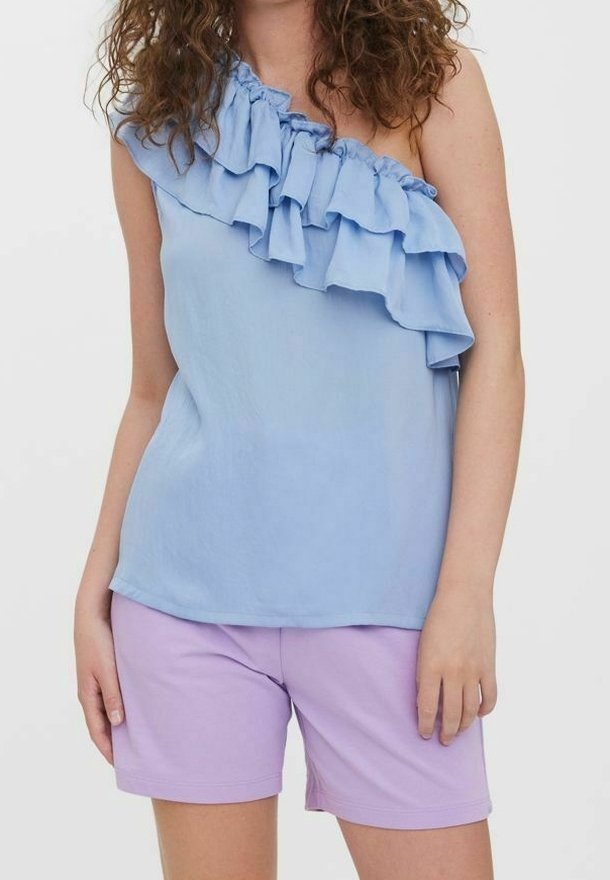 Light blue, one-shoulder top with ruffled accent; soft fabric, relaxed fit. Paired with lavender shorts, smooth texture, knee-length.
