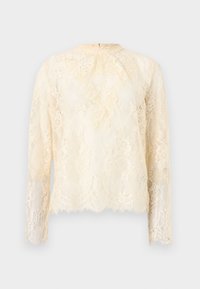 Haut en dentelle à manches longues de couleur crème clair, doté d'un ourlet festonné et d'un col montant. Motif de dentelle florale complexe avec une texture transparente en superposition.
