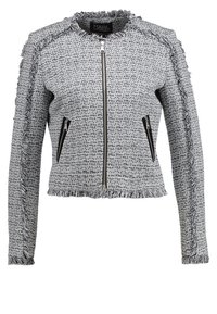 Grå tweedjacka med fransdetaljer, dragkedjestängning och två dragkedjefickor. Strukturerad design med texturerad tyg och långa ärmar.