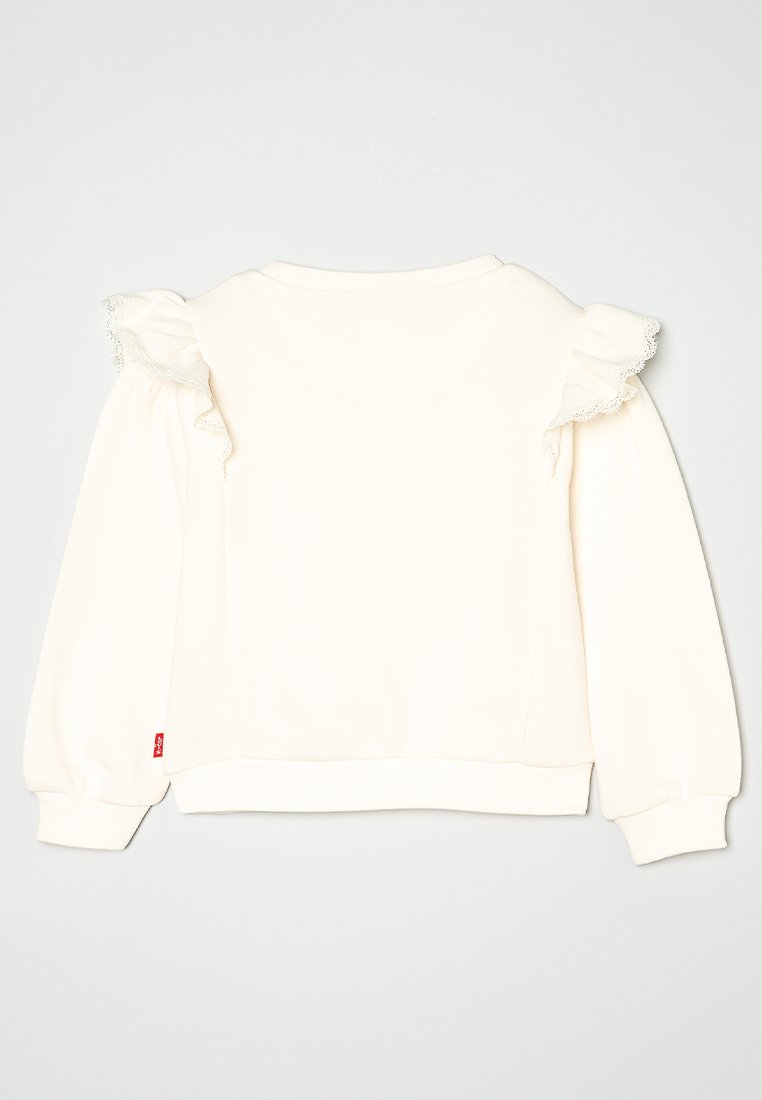 Cremfarbener Kapuzenpullover mit Rüschendetails an den Schultern, langen Ärmeln, gerippten Bündchen und einem kleinen Markenschild an der Seite.