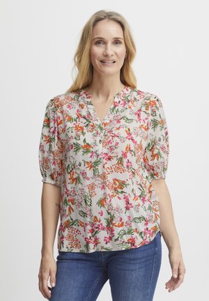 Floral blouse featuring short puff sleeves, a notch collar, and a light cream background adorned with vibrant pink, orange, and green patterns.