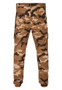 Camo cargobroeken in een tan- en bruin kleurenpalet, met een relaxte pasvorm, elastische manchetten en meerdere zakken voor opbergruimte.
