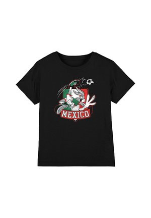 Black t-shirt with a cartoon character playing soccer, wearing green and white, kicking a ball above the word "Mexico" on a red and green background.