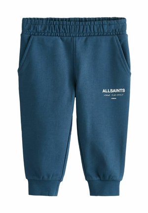 Kék melegítőnadrág elasztikus derékpánttal, oldalsó zsebekkel és bordázott mandzsettákkal. Az elején fehér színű "ALLSAINTS" logóval.