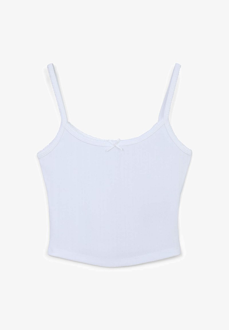 Camisola bianca in cotone con spalline sottili regolabili, scollatura quadrata e un dettaglio a fiocco decorativo al centro frontale. Tessuto liscio.