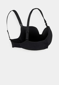 Sutiã preto com alças ajustáveis, design sem costura e fecho de gancho e olho. Feito em tecido suave com uma leve textura e detalhes.