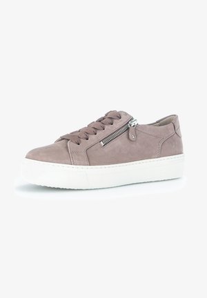 Suede sneaker in light taupe with a white rubber sole, featuring a side zipper and flat laces. Rounded toe and minimal stitching details.