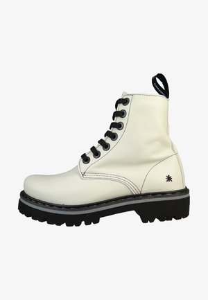 White leather ankle boot with black laces, thick black sole, and contrasting stitching. Features a pull tab and a small logo on the side.