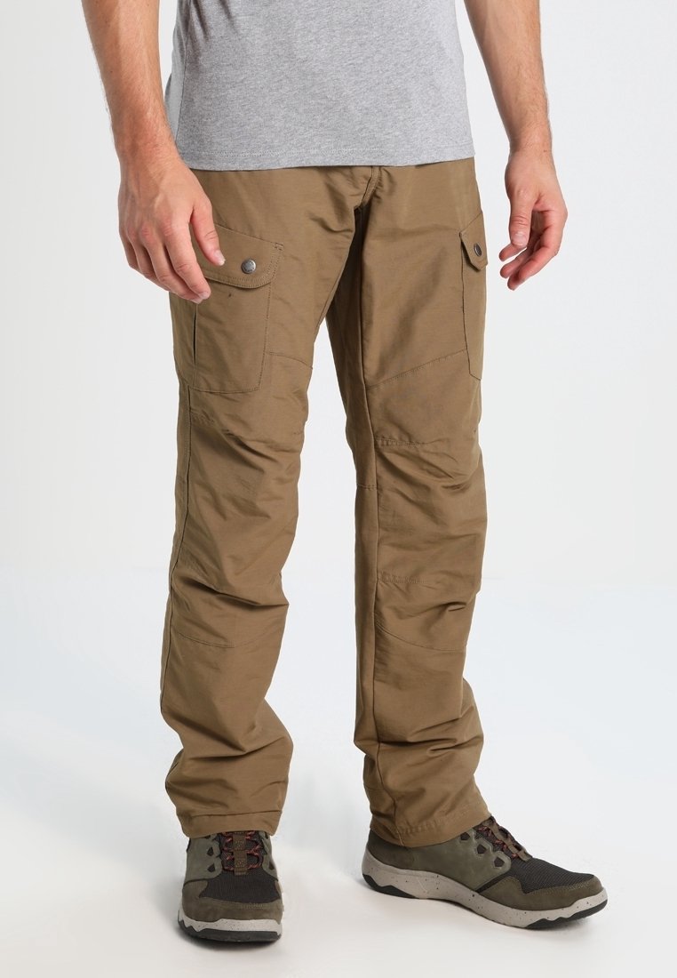 Beige cargo pants with multiple pockets, button accents, straight leg design, and a smooth texture, worn with gray shoes and a gray shirt.