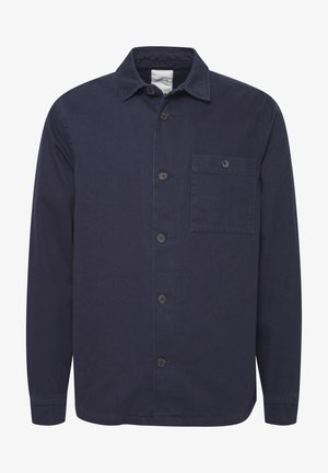 Sötétkék gombos ing strapabíró anyagból. Széles gallérral, hosszú ujjakkal és elülső zsebbel rendelkezik. Simább textúra, klasszikus design.