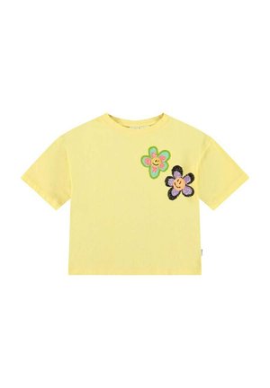 Geel katoenen T-shirt met korte mouwen, voorzien van twee kleurrijke bloemapplicaties in roze, groen en zwart met lachende gezichten.