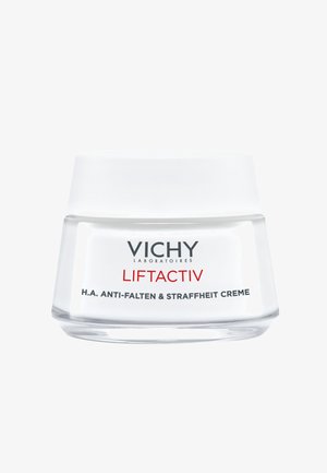 Vichy Liftactiv cream in a clear glass jar with a frosted lid. Label features black and red text detailing product type and benefits.