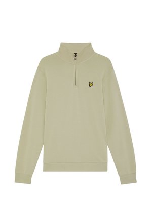 Sudadera de color beige claro con media cremallera, hecha de tela suave, con mangas largas y un pequeño logo de un pájaro negro y amarillo en el pecho izquierdo.
