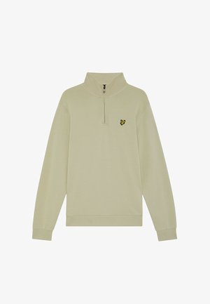 Sudadera de color beige claro con media cremallera, hecha de tela suave, con mangas largas y un pequeño logo de un pájaro negro y amarillo en el pecho izquierdo.