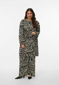 Ensemble noir et crème à motifs, composé d'un long haut avec une ceinture nouée à la taille et d'un pantalon fluide, tous deux ornés de dessins tourbillonnants complexes.