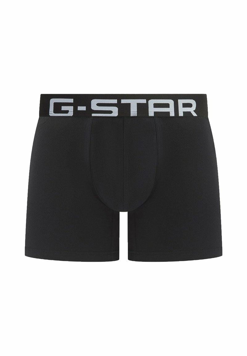 Zwarte boxershorts met een aansluitende pasvorm, gemaakt van glad materiaal, met een brede elastische tailleband waarop 'G-STAR' in lichtgrijs is gedrukt.