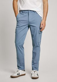 Light blue cargo pants made of cotton with side pockets, a straight leg design, and a waistband featuring a button and zipper closure.