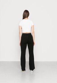 NA-KD SOFT PANTS - Calças - black