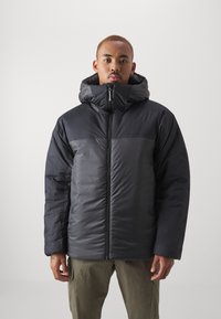 Black puffer jacket with a high collar, zip closure, and a mix of matte and shiny textures. Features a relaxed fit and long sleeves.