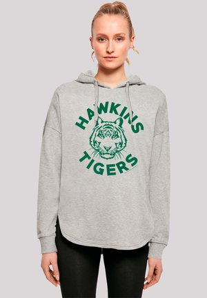 Hellgrauer Hoodie mit einem grünen Tiger-Graphic und dem Text "HAWKINS TIGERS". Hat eine lockere Passform und eine Kordelzugkapuze. Weicher Stoff, lässiges Design.