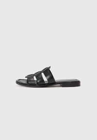 Black leather slide sandals with three wide straps, a flat sole, and soft texture. Simple design with minimal detailing.