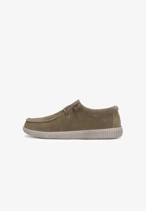 Olive green suede slip-on shoe with a textured rubber sole, stitched detailing, and textile lining. Features decorative laces and logo.