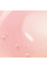 Gel rosa luccicante con fini particelle di glitter, caratterizzato da una consistenza liscia e bolle riflettenti tonde, creando una finitura luminosa.